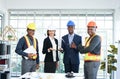 Confident teamwork project engineers or architects standing in the office room after meeting Royalty Free Stock Photo
