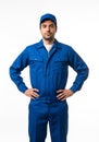 Confident Technician in Blue Uniform Stands Ready on White Background, Professional Service Concept Royalty Free Stock Photo