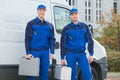 Confident Technicians Standing Against Truck Royalty Free Stock Photo