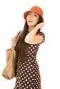 Confident teen girl model wearing a polka dot dress orange hat w Royalty Free Stock Photo