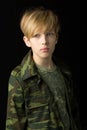 Confident teenage boy in camouflage clothin Royalty Free Stock Photo