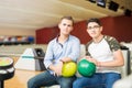 Teenage Friends With Bowling Balls Sitting In Club Royalty Free Stock Photo