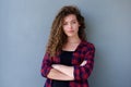 Confident teenage girl standing with arms crossed