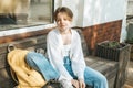 A confident teenage girl with striking red short hair poses for a lively portrait