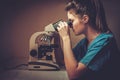 Confident veterinarian examining the test under the microscope in Veterinary clinic. Royalty Free Stock Photo