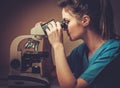 Confident veterinarian examining the test under the microscope in Veterinary clinic. Royalty Free Stock Photo