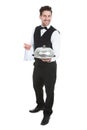 Confident waiter holding domed tray Royalty Free Stock Photo