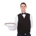 Confident waiter holding empty tray Royalty Free Stock Photo