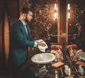 Confident well-dressed man in Luxury bathroom interior.