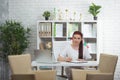 Confident woman doctor sitting at the table in her office and smiling at camera. healthcare concept Royalty Free Stock Photo