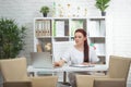 Confident woman doctor sitting at the table in her office and smiling at camera. healthcare concept Royalty Free Stock Photo