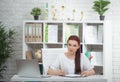 Confident woman doctor sitting at the table in her office and smiling at camera. healthcare concept Royalty Free Stock Photo