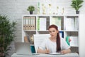 Confident woman doctor sitting at the table in her office and smiling at camera. healthcare concept Royalty Free Stock Photo