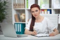 Confident woman doctor sitting at the table in her office and smiling at camera. healthcare concept Royalty Free Stock Photo