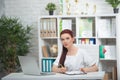 Confident woman doctor sitting at the table in her office and smiling at camera. healthcare concept Royalty Free Stock Photo