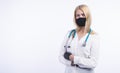 Confident woman doctor wearing medical mask standing with crossed arms.  female portrait. Royalty Free Stock Photo