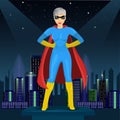 Confident woman dressed in superhero costume watching over night city