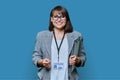 Confident woman with education center card on blue background Royalty Free Stock Photo