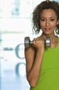 Confident Woman Lifting Dumbbell In Club