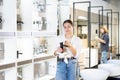 Confident woman picking out new bathroom faucet in store Royalty Free Stock Photo