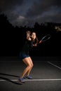 confident woman with racket ready to hit tennis ball. Royalty Free Stock Photo