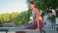 Confident woman raising legs exercising on parallel bars closeup. Woman training Royalty Free Stock Photo