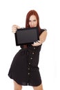 A Confident Woman With Red Hair holds a tablet computer out in f Royalty Free Stock Photo