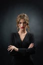 Confident woman wearing red lipstick posing in front of camera.