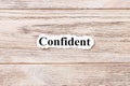 Confident of the word on paper. concept. Words of confident on a wooden background