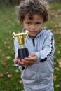 Confident Young African American Athlete proudly holding a trophy. Royalty Free Stock Photo