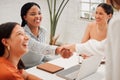 Confident young african american businesswoman shaking hands with colleague during a meeting in an office. Motivated Royalty Free Stock Photo