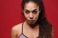 Confident young african american sports fitness woman in sportswear posing working out isolated on red wall background Royalty Free Stock Photo