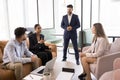 Confident young African business professional woman talking to diverse team Royalty Free Stock Photo