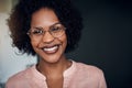 African businesswoman standing in a modern office smiling confidently Royalty Free Stock Photo