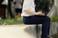 Confident young Asian business man in formal wear using laptop for his job at the park during morning time Royalty Free Stock Photo