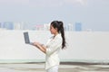 Confident young Asian business woman holding laptop with hands. Internet and technology concept Royalty Free Stock Photo