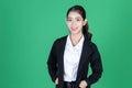 Confident young Asian business woman smiling on green isolated background Royalty Free Stock Photo