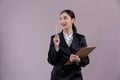 Confident young asian businesswoman in formal suit pointing finger. Enthusiastic Royalty Free Stock Photo