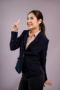 Confident young asian businesswoman in formal suit pointing finger. Enthusiastic Royalty Free Stock Photo