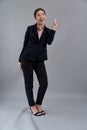 Confident young asian businesswoman in formal suit pointing finger. Enthusiastic Royalty Free Stock Photo