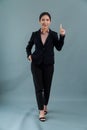 Confident young asian businesswoman in formal suit pointing finger. Enthusiastic Royalty Free Stock Photo