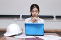 Confident young Asian businesswoman working on the workplace in modern office. Thinking and thoughtful business concept Royalty Free Stock Photo