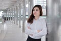 Confident young Asian busineswoman leaning a pole at walkway outside office. Leader business woman concept. Royalty Free Stock Photo