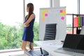 Confident young Asian executive woman looking through windows in office. Thoughtful and leadership business concept Royalty Free Stock Photo