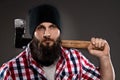 Confident young bearded lumberjack man carrying an axe Royalty Free Stock Photo