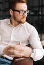 Confident young bearded man with glasses in trendy clothing looking away Royalty Free Stock Photo