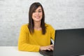 Confident young beautiful businesswoman with laptop at office Royalty Free Stock Photo