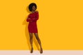 Confident Young Black Fashion Model In Red Mini Dress And High Heels Is Posing With Arms Crossed Royalty Free Stock Photo