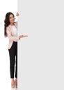 Confident young business woman presenting blank board Royalty Free Stock Photo