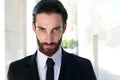 Confident young businessman with beard in black suit and tie Royalty Free Stock Photo